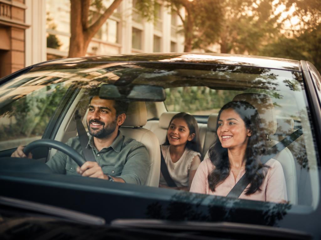 A happy family driving their freshly cleaned car in Bengaluru East